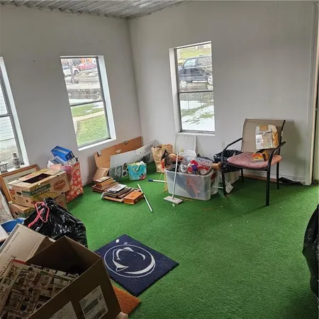 a living room with furniture a window and a table