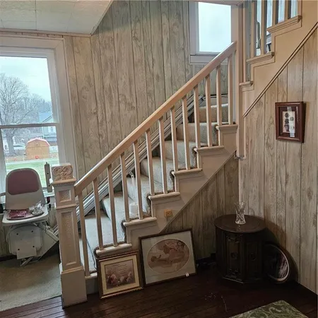 a view of entryway and hall with wooden floor