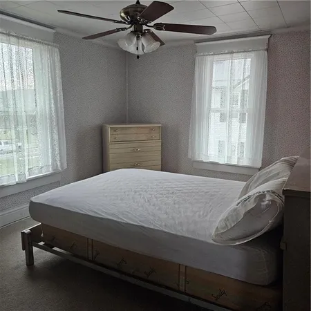 a bedroom with a bed and window