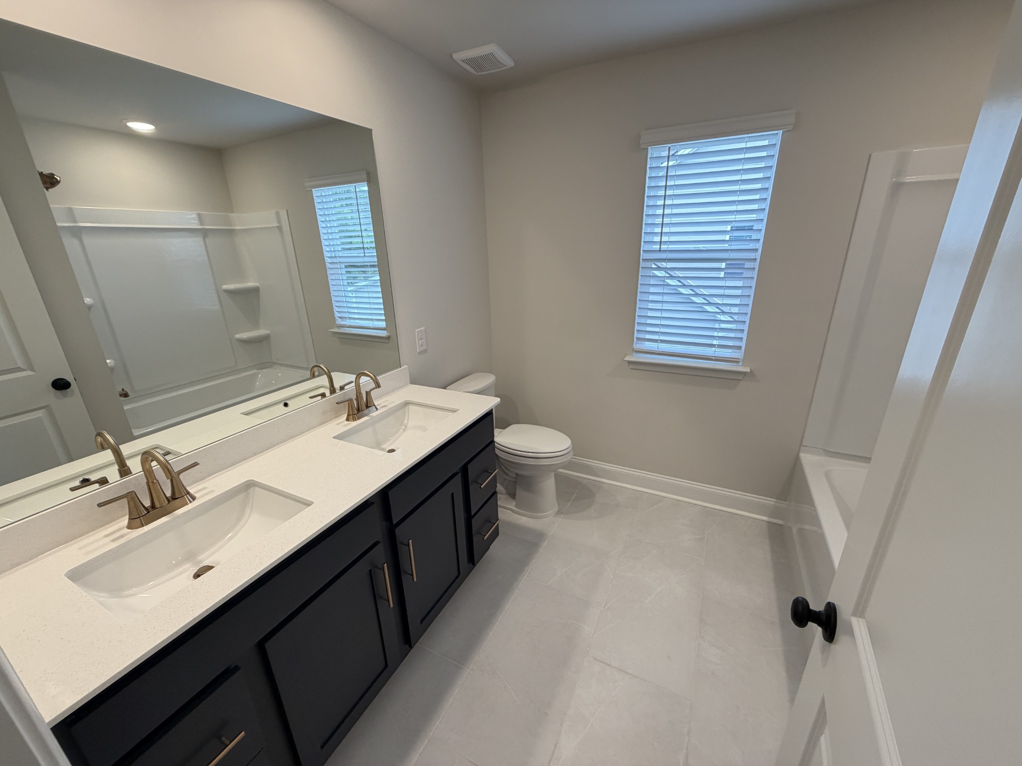 147 Emeline Way Mount Juliet, TN 37122 - Photo 26 of 41 a bathroom with a double vanity sink a toilet and a mirror