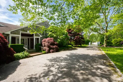 a view of a house with a tree and plants