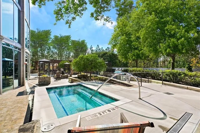 a view of a patio with chairs and a table with potted plants