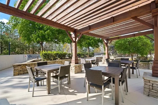 a view of a patio with a table chairs and backyard