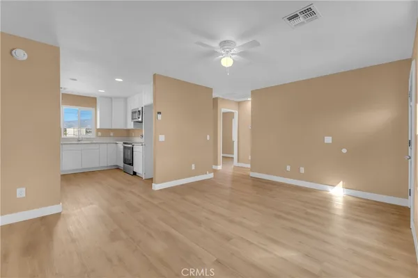 a view of a kitchen with a sink and a refrigerator