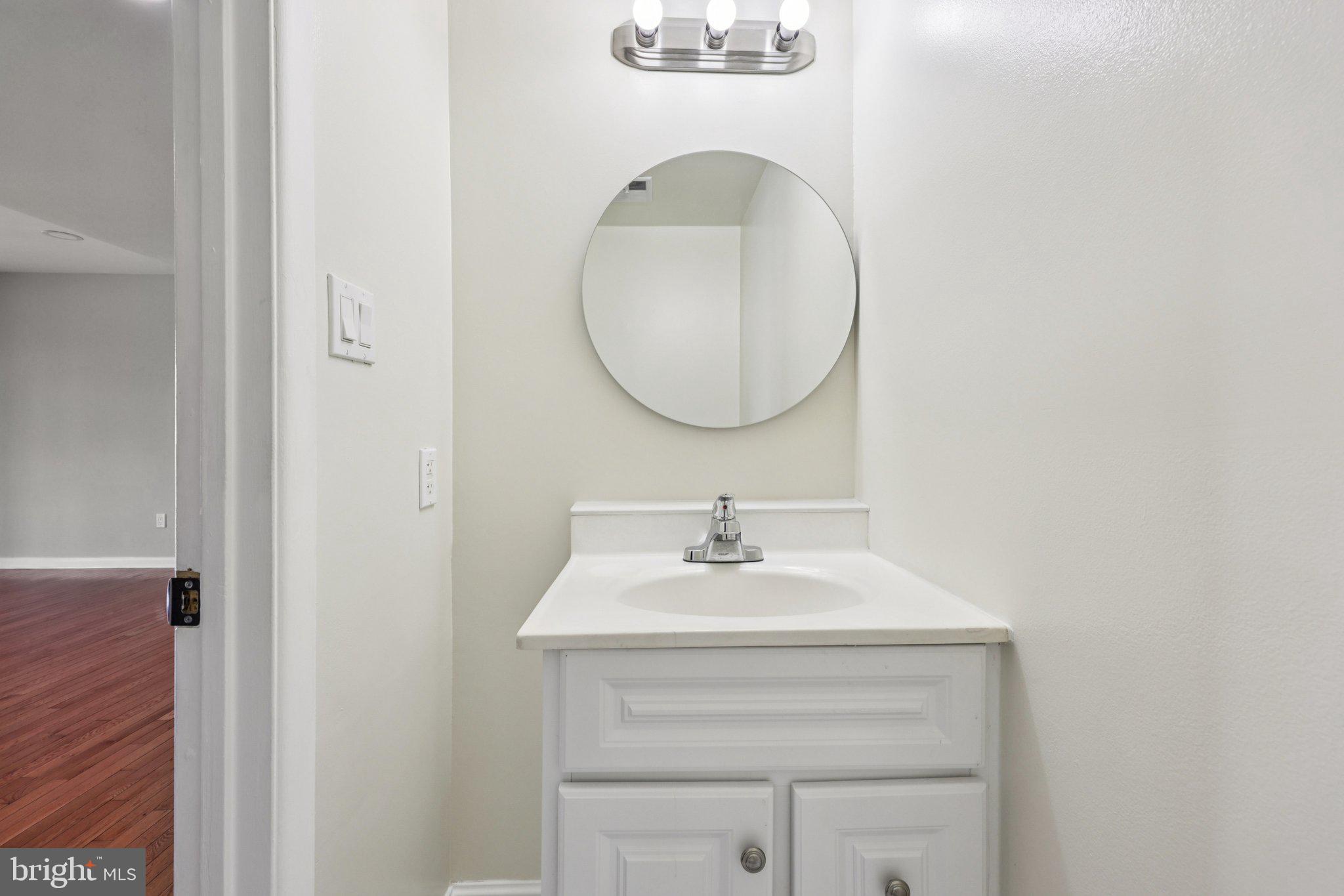 500 Giles Place Sterling, VA 20164 - Photo 14 of 41 a bathroom with a sink and a mirror