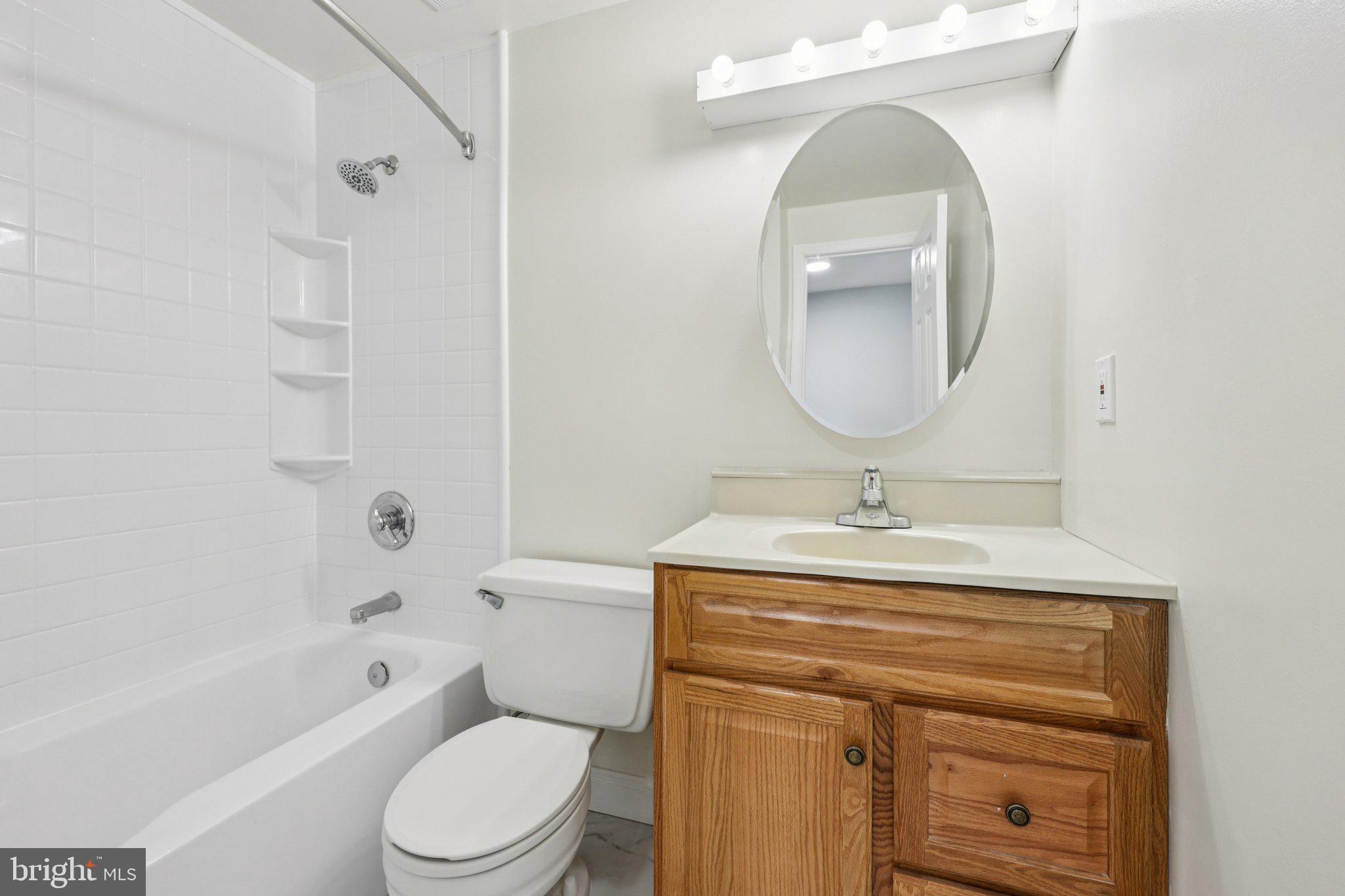 500 Giles Place Sterling, VA 20164 - Photo 28 of 41 a bathroom with a toilet a sink and mirror