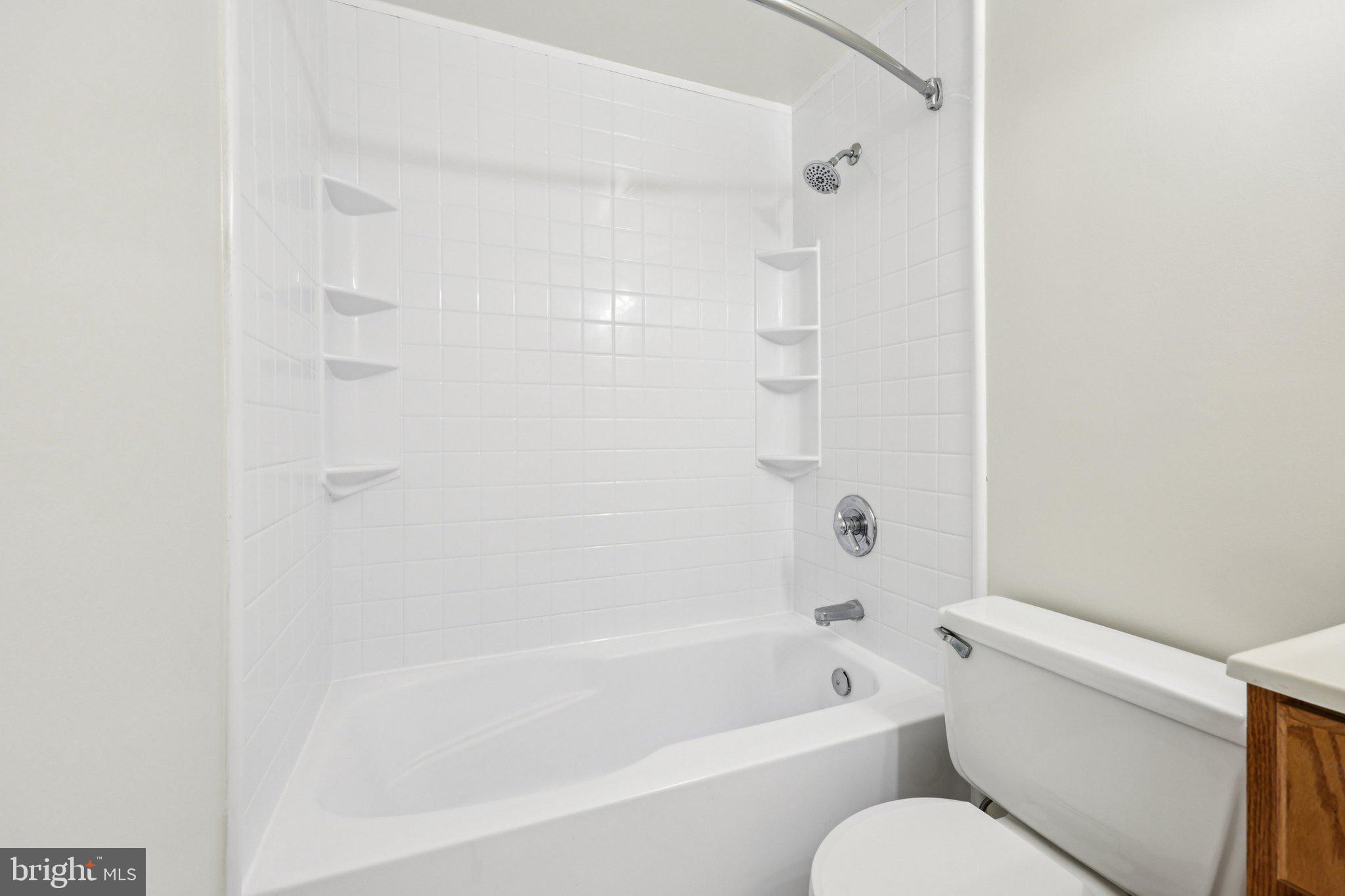 500 Giles Place Sterling, VA 20164 - Photo 29 of 41 a white bath tub sitting next to a white toilet