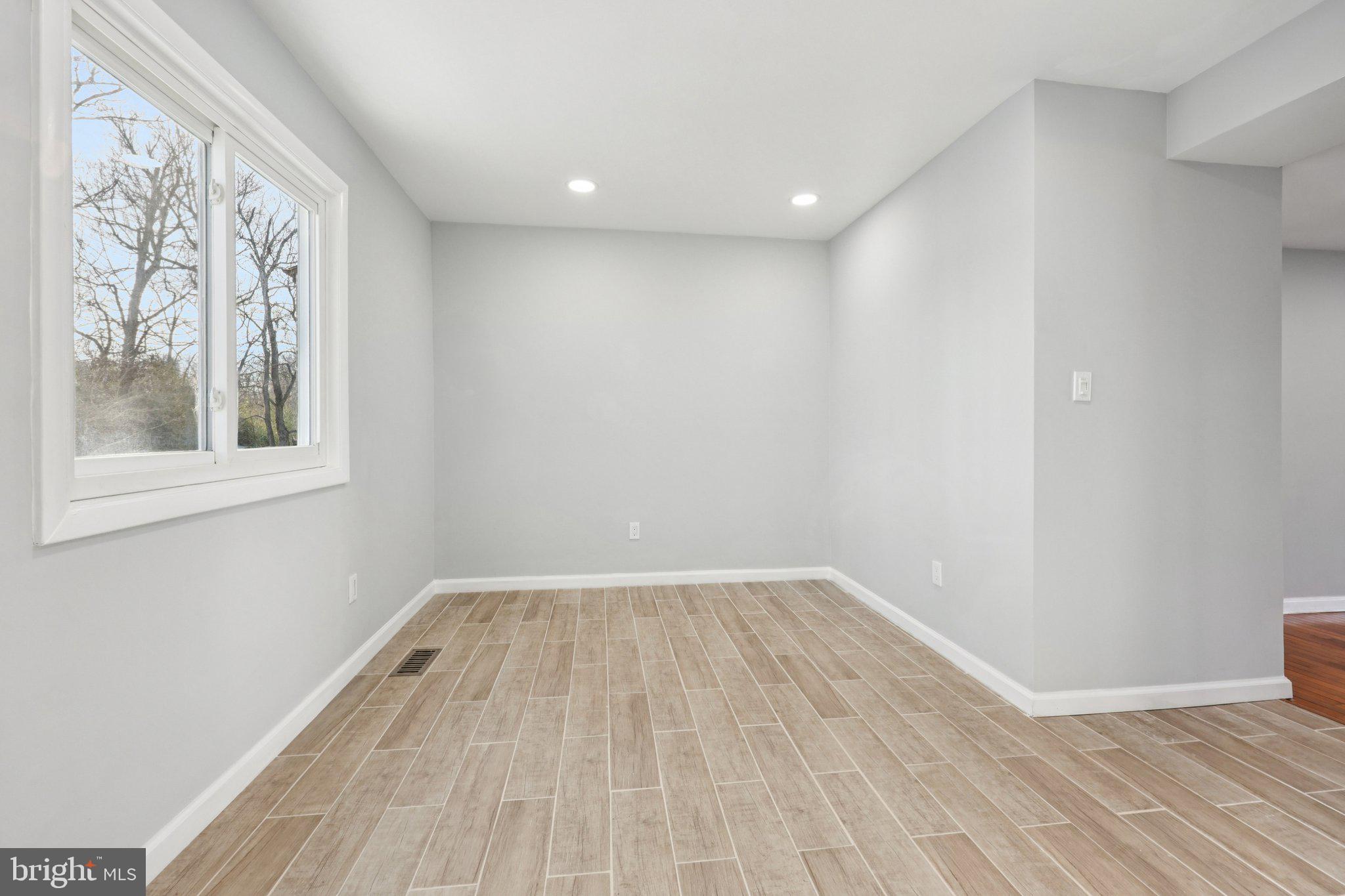500 Giles Place Sterling, VA 20164 - Photo 9 of 41 a view of an empty room with wooden floor and a window