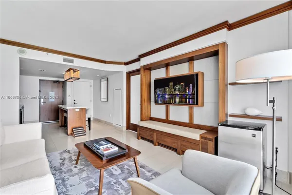 a living room with furniture and a painting on the wall