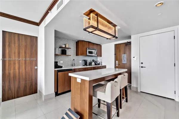a kitchen with stainless steel appliances granite countertop a sink and a refrigerator