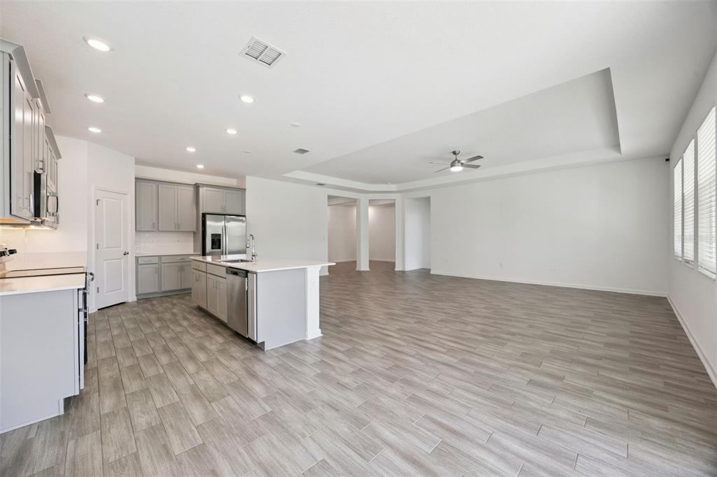 6298 Lakepine Street St. Cloud, FL 34771 - Photo 13 of 41 a view of kitchen with wooden floor and electronic appliances