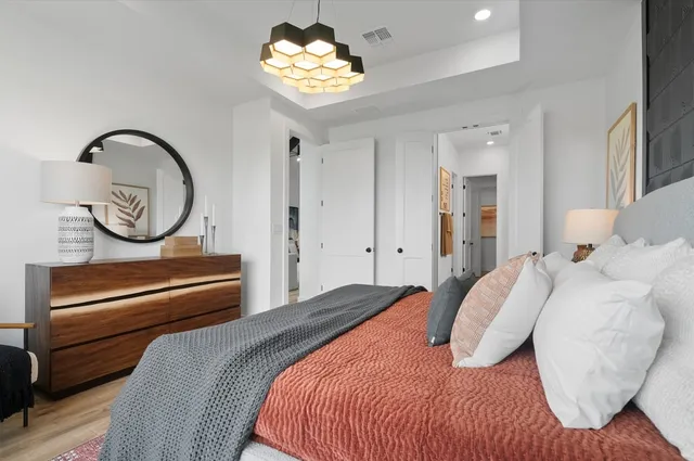 a spacious bedroom with a bed and a couch