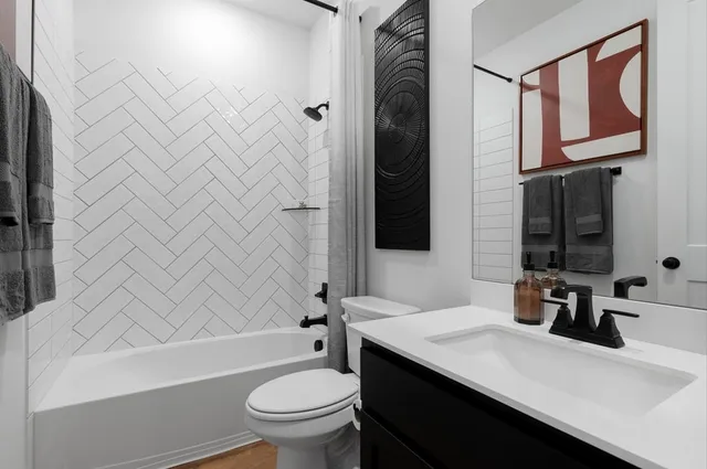 a bedroom with a large bed and a potted plant