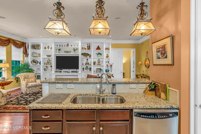 a kitchen with stainless steel appliances granite countertop a sink and a stove