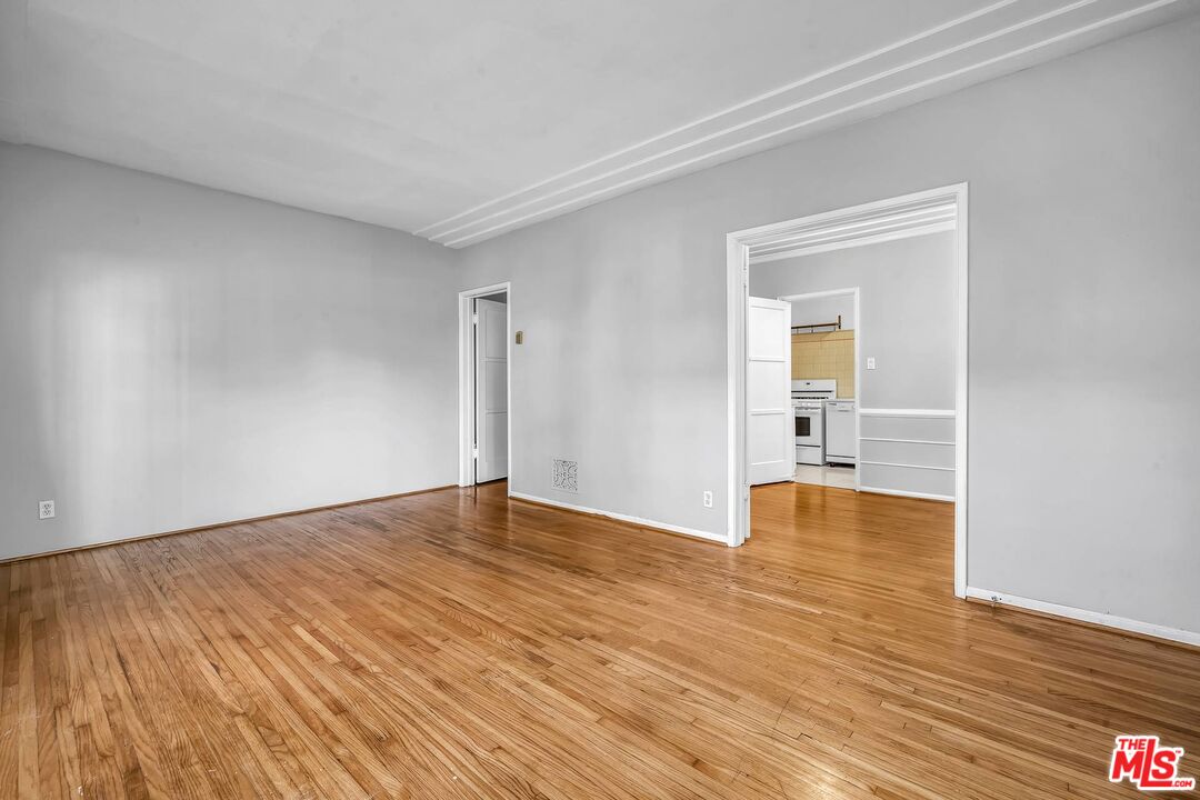 9000 Burton Way Beverly Hills, CA 90211 - Photo 5 of 26 a view of empty room with wooden floor and fan