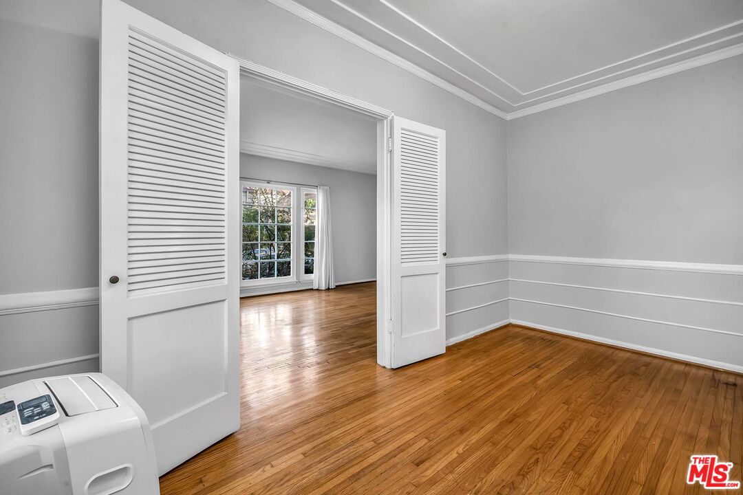 9000 Burton Way Beverly Hills, CA 90211 - Photo 7 of 26 a view of a room with wooden floor and white walls