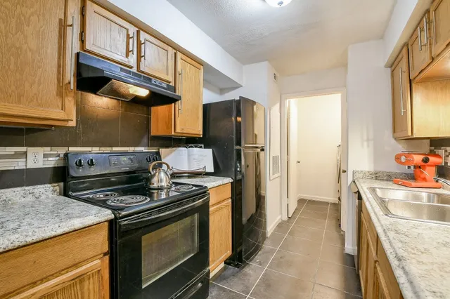 a kitchen with stainless steel appliances granite countertop a stove and a sink