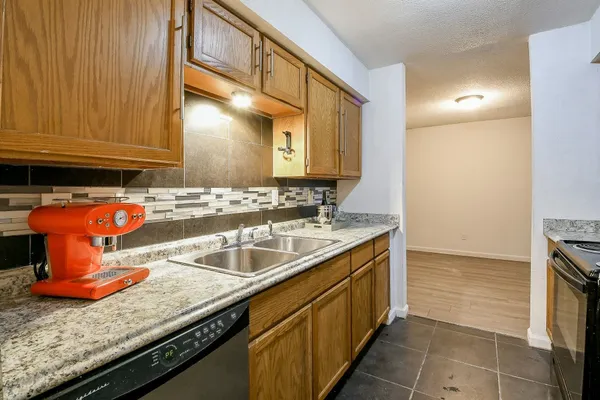 a kitchen with stainless steel appliances granite countertop a sink and cabinets