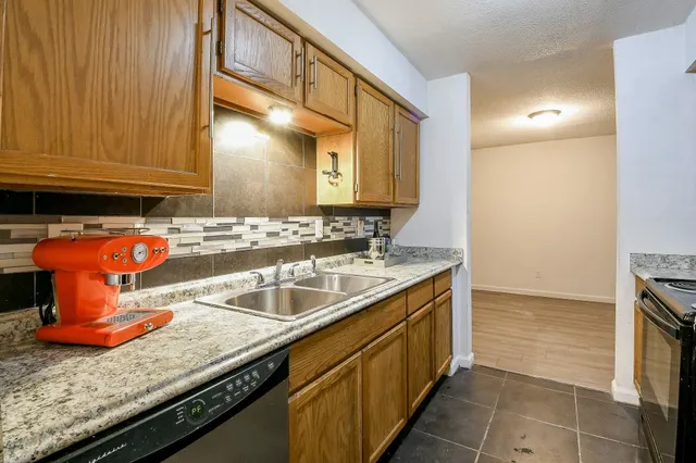a kitchen with stainless steel appliances granite countertop a sink and cabinets
