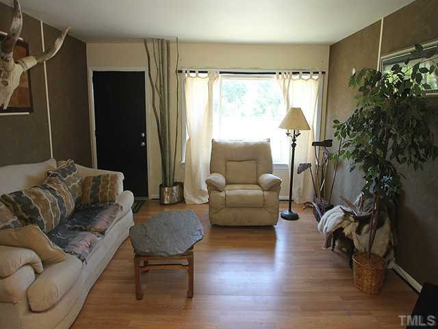 4812 Tryon Road Raleigh, NC 27606 - Photo 3 of 12 a living room with furniture and a large window