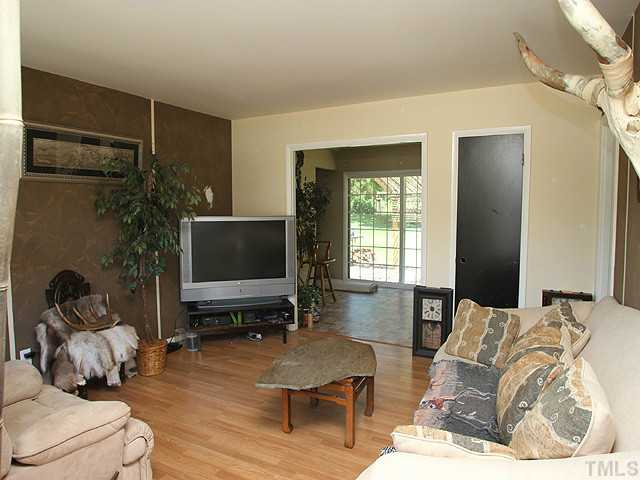 4812 Tryon Road Raleigh, NC 27606 - Photo 4 of 12 a living room with furniture and a flat screen tv