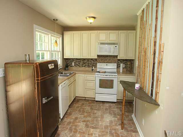 4812 Tryon Road Raleigh, NC 27606 - Photo 5 of 12 a kitchen with a refrigerator sink and stove top oven