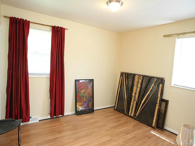 4812 Tryon Road Raleigh, NC 27606 - Photo 8 of 12 a view of a livingroom with wooden floor and a window