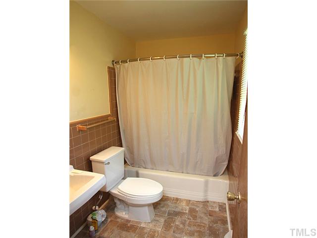 4812 Tryon Road Raleigh, NC 27606 - Photo 10 of 12 a bathroom with a toilet a sink and a shower