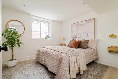 a bedroom with bed and a window