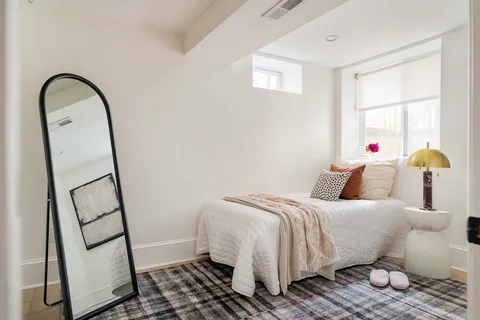 a bedroom with a bed and wooden floor