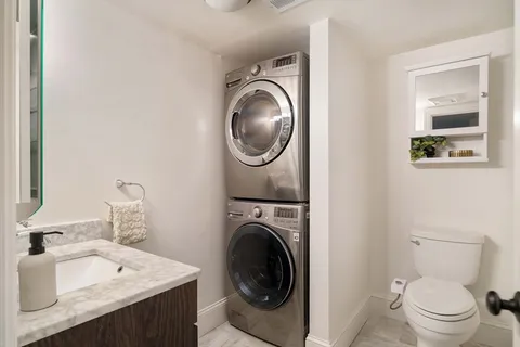 a utility room with sink dryer and washer
