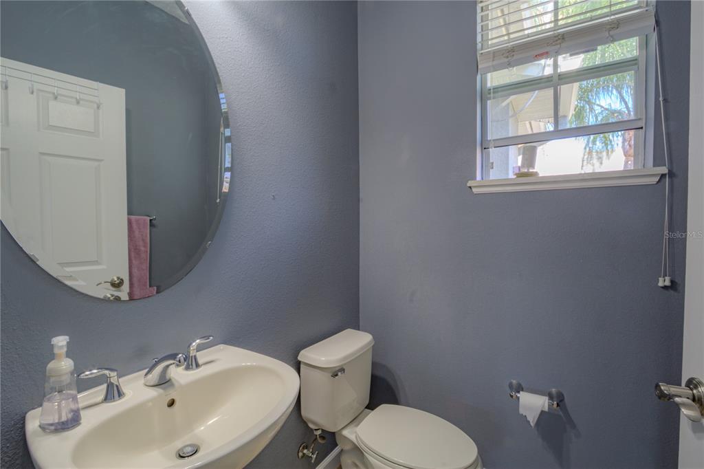 762 Terrace Spring Drive Orlando, FL 32828 - Photo 13 of 26 a bathroom with a toilet sink and mirror