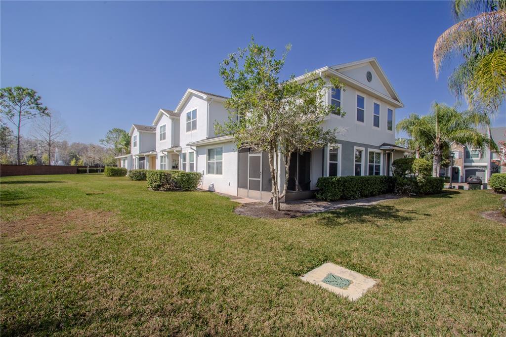 762 Terrace Spring Drive Orlando, FL 32828 - Photo 26 of 26 a view of a white house with a yard and plants