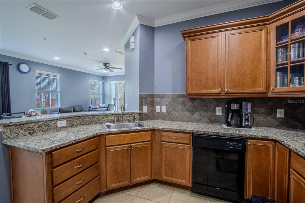 762 Terrace Spring Drive Orlando, FL 32828 - Photo 4 of 26 a kitchen with stainless steel appliances granite countertop a sink and cabinets