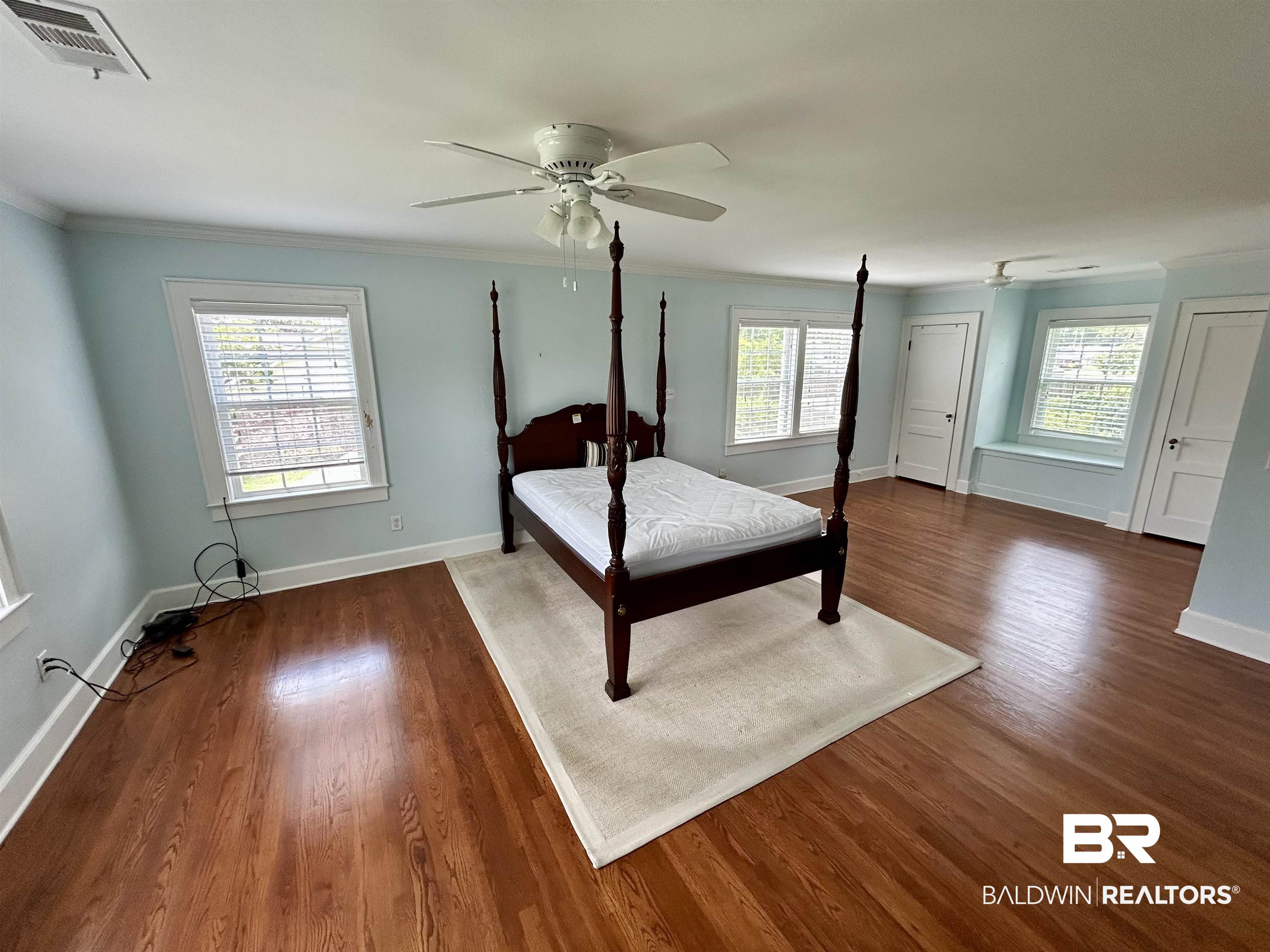 1405 Escambia Avenue Brewton, AL 36426 - Photo 11 of 16 Bedroom with crown molding, wood finished floors, multiple windows, and a ceiling fan