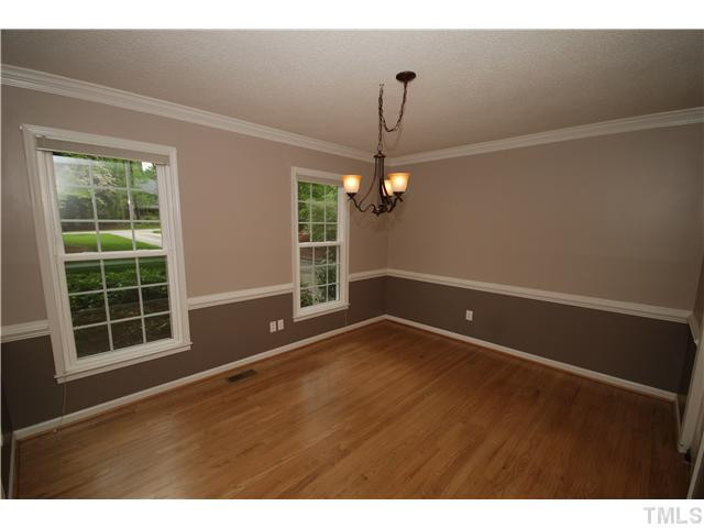 8304 Heel Stone Court Raleigh, NC 27613 - Photo 8 of 25 The Dining room features beautiful hardwood floors, chair rail and crown molding. Dining Room
