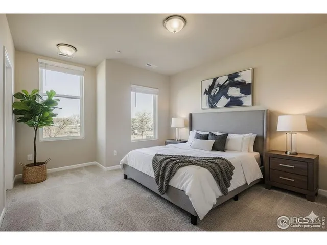 a bedroom with a bed and a potted plant