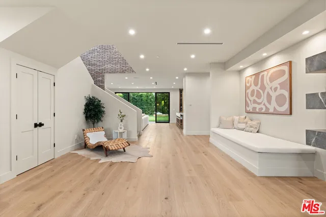 a living room with furniture fireplace and a large window