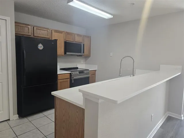 a kitchen with a refrigerator and a sink