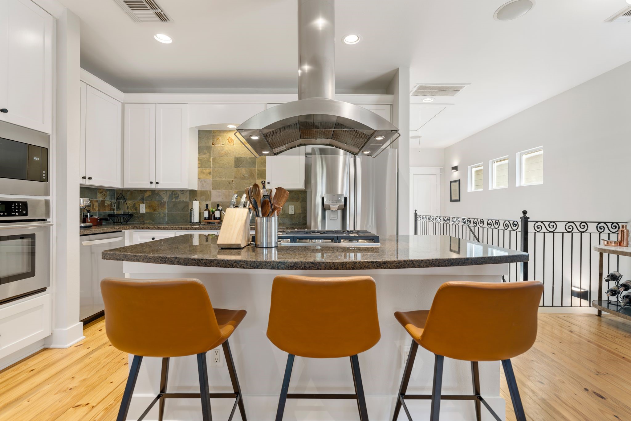 1408 Asbury Street Houston, TX 77007 - Photo 10 of 24 a kitchen with stainless steel appliances granite countertop a table chairs and a refrigerator