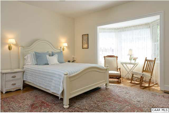 871 Tanglewood Road Charlottesville, VA 22901 - Photo 15 of 33 a bedroom with a bed a chair and next to a window
