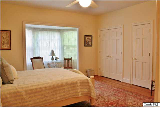 871 Tanglewood Road Charlottesville, VA 22901 - Photo 27 of 33 a room with a bed and wooden floor