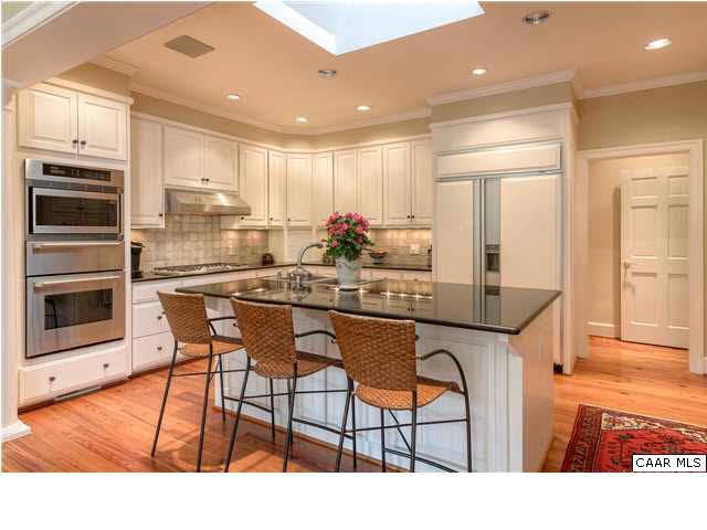 871 Tanglewood Road Charlottesville, VA 22901 - Photo 6 of 33 a kitchen with stainless steel appliances kitchen island granite countertop a table chairs sink and cabinets