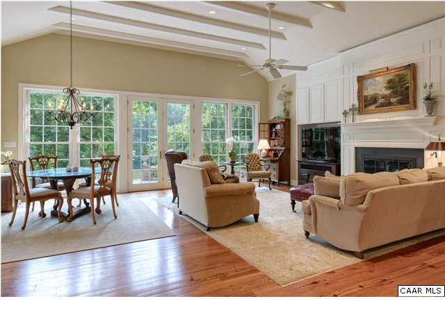 871 Tanglewood Road Charlottesville, VA 22901 - Photo 9 of 33 a living room with furniture a fireplace and a dining table with wooden floor