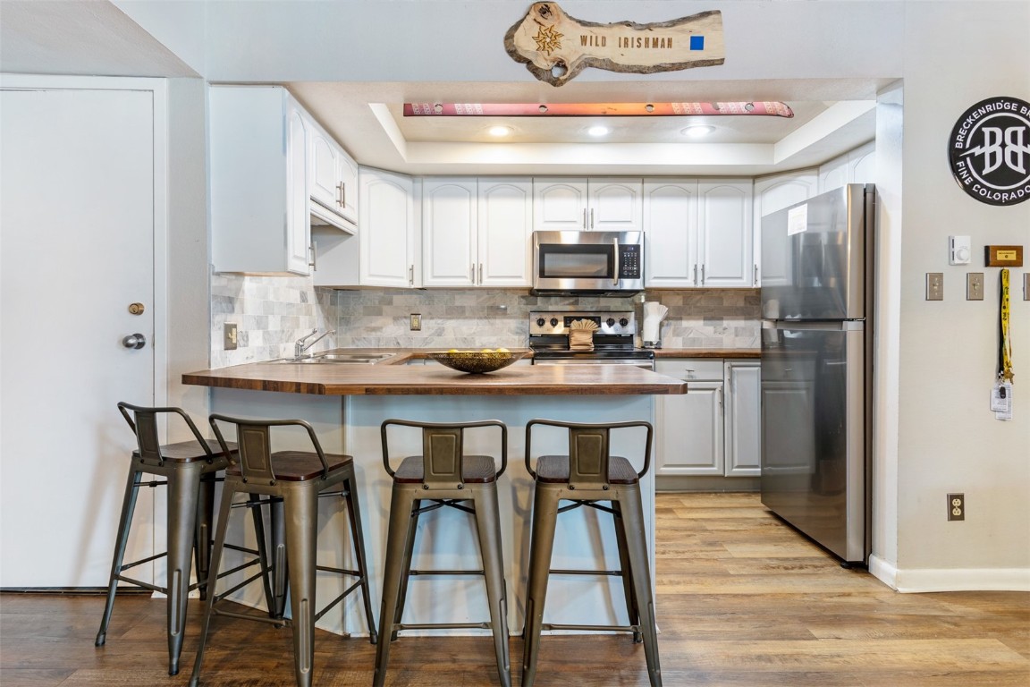 a kitchen with kitchen island granite countertop stainless steel appliances a sink and a refrigerator