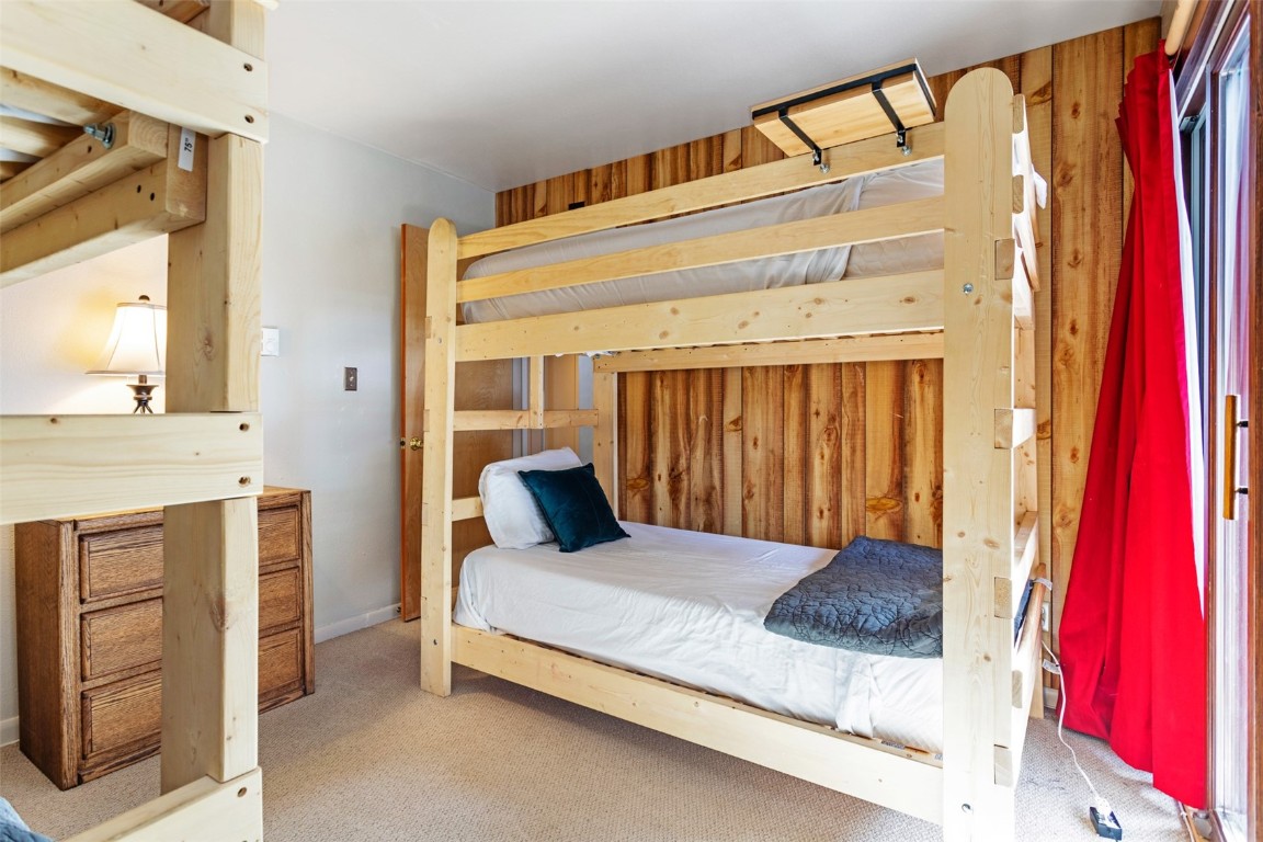 433 Wild Irishman Road, Unit 12101 Keystone, CO 80435 - Photo 11 of 20 a bedroom with a bed and a mirror on the dresser