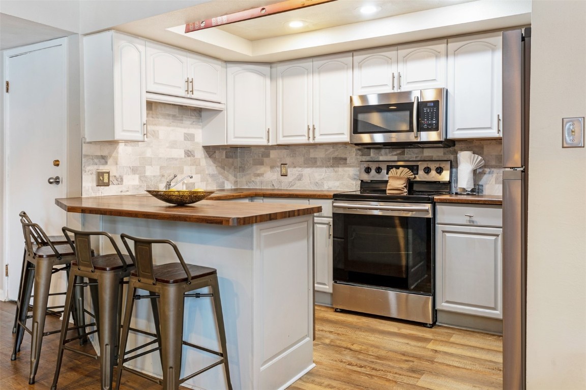 433 Wild Irishman Road, Unit 12101 Keystone, CO 80435 - Photo 3 of 20 a kitchen with stainless steel appliances a stove a sink and a microwave