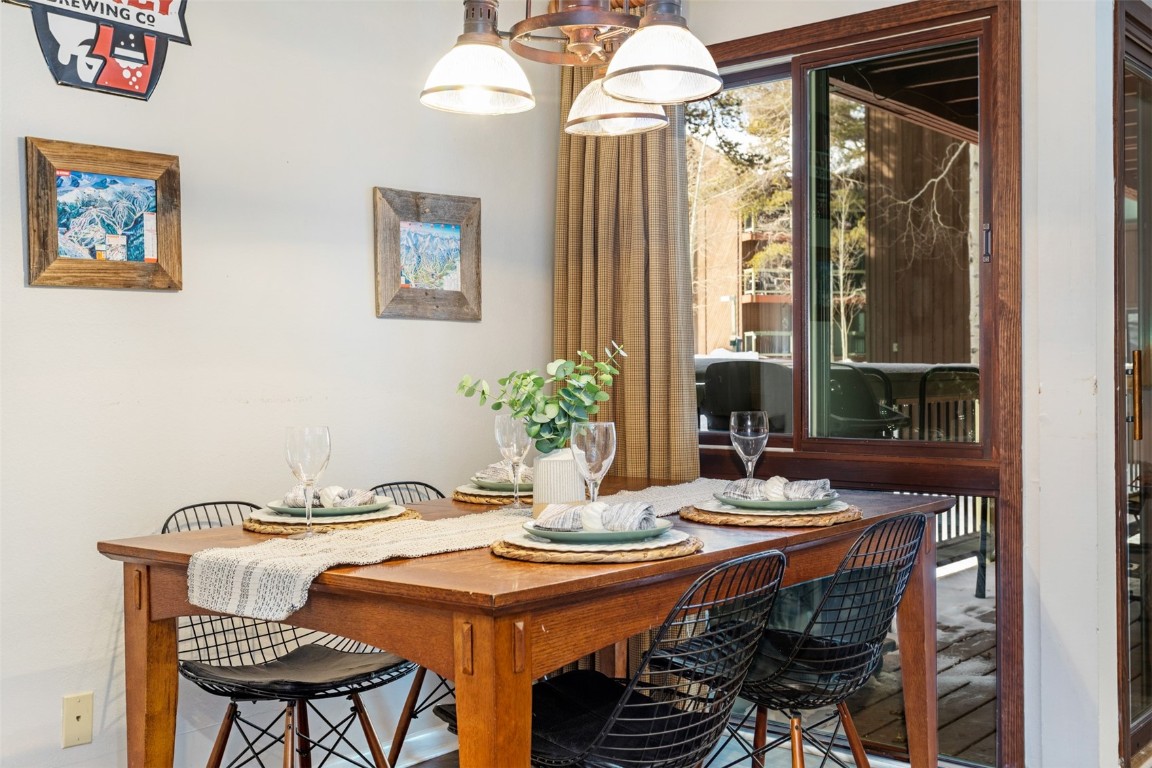 433 Wild Irishman Road, Unit 12101 Keystone, CO 80435 - Photo 5 of 20 a dining room with furniture a potted plant and a chandelier