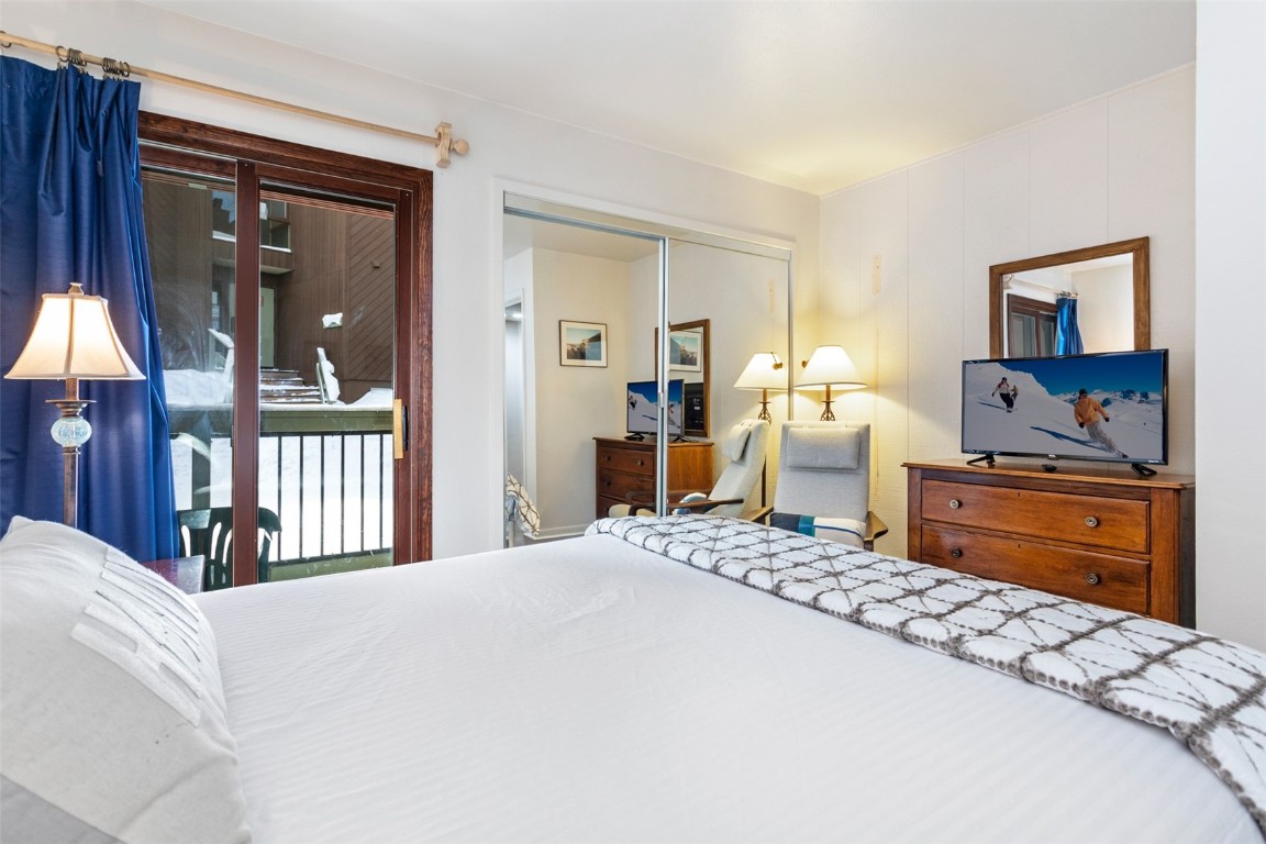 433 Wild Irishman Road, Unit 12101 Keystone, CO 80435 - Photo 9 of 20 a bedroom with a bed and dresser with mirror