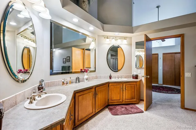 a bathroom with a double vanity sink and a mirror